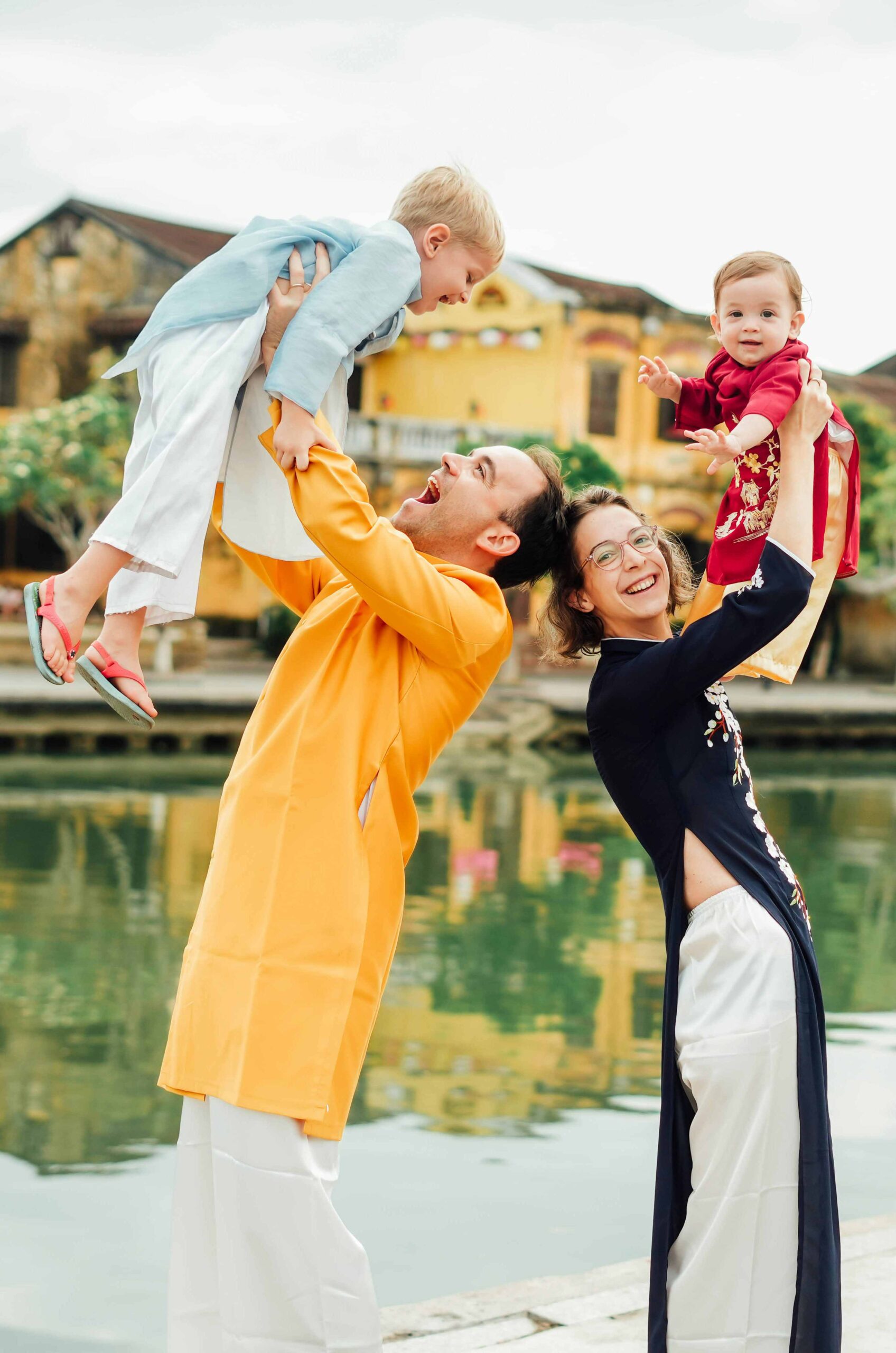 A foreign family wearing traditional Ao Dai in Hoi An, illustrating the benefits of a Vietnam Visa TT for family reunification